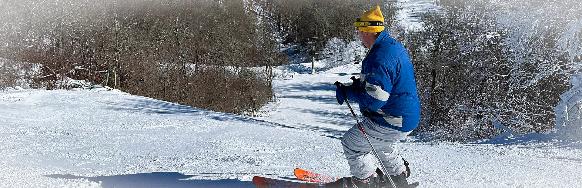 Skiier on slope 1920×300